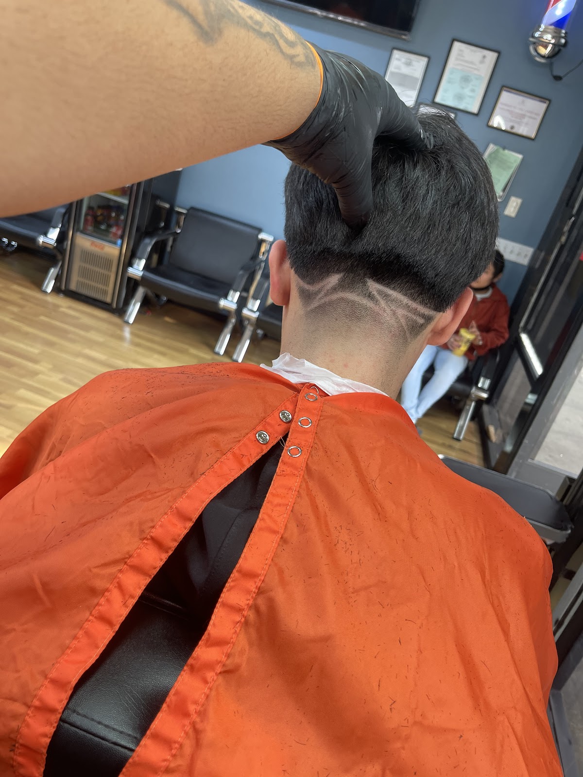 Freehand razor design cut into the back of a client's hair