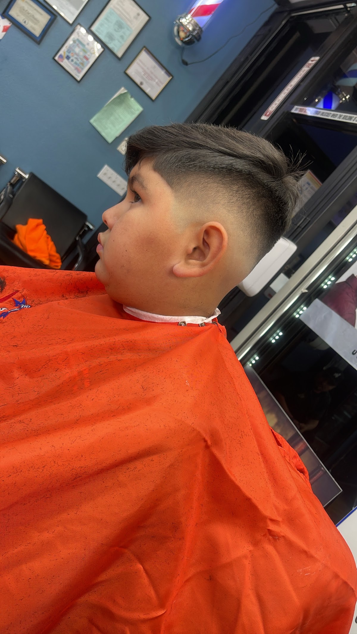 A clean mid fade finished at the shop